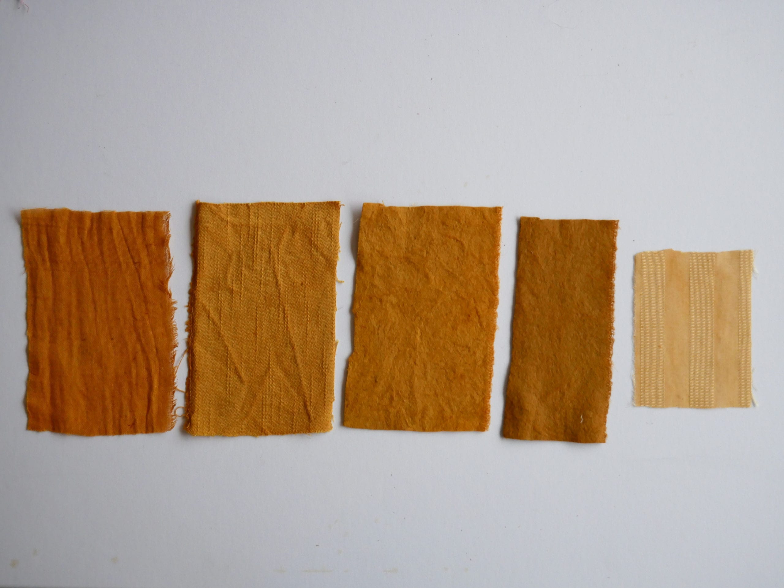 Onion skin natural dye samples on different substrates